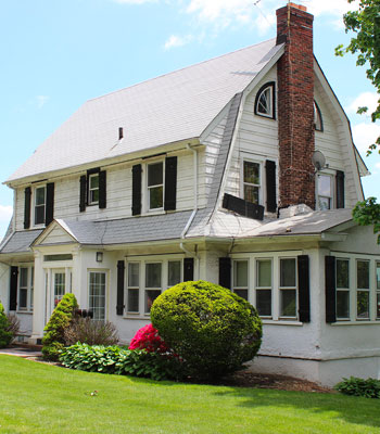 Two story house with a new grey shingle roof in Massachusetts